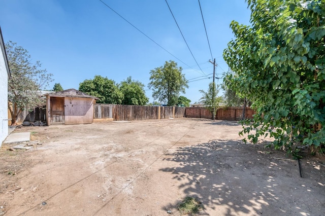 153 Birch, Fresno, CA 93650 - fenced backyard featuring a storage shed and an outdoor structure