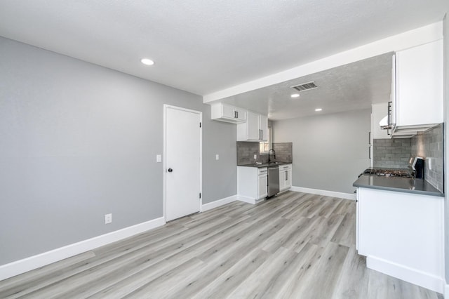 153 Birch, Fresno, CA 93650 - kitchen with dark countertops, decorative backsplash, stainless steel dishwasher, white cabinets, and recessed lighting