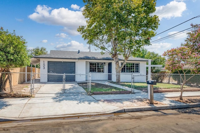 153 Birch, Fresno, CA 93650 - view of front of property featuring a garage, stucco siding, a fenced front yard, and driveway