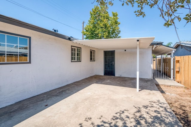 153 Birch, Fresno, CA 93650 - back of house with fence, a carport, and stucco siding