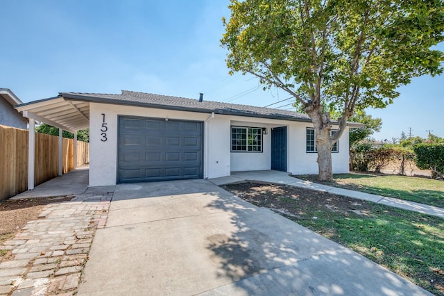 153 Birch, Fresno, CA 93650 - ranch-style home with stucco siding, fence, concrete driveway, and a garage