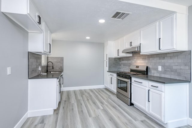 153 Birch, Fresno, CA 93650 - kitchen with gas stove, dark countertops, baseboards, light wood finished floors, and recessed lighting