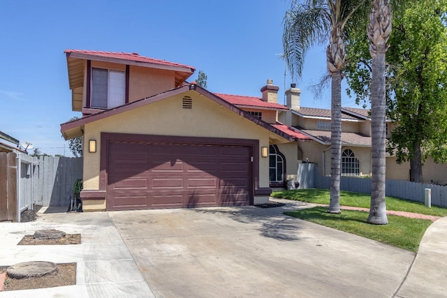 3626 E Stewart Ct, Visalia, CA 93292 - mediterranean / spanish house featuring stucco siding, a garage, fence, and driveway