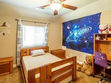 bedroom with carpet floors, a ceiling fan, and baseboards