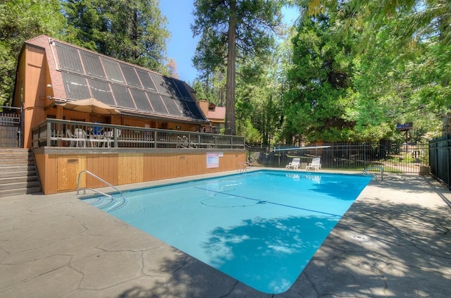 community pool with fence and stairs