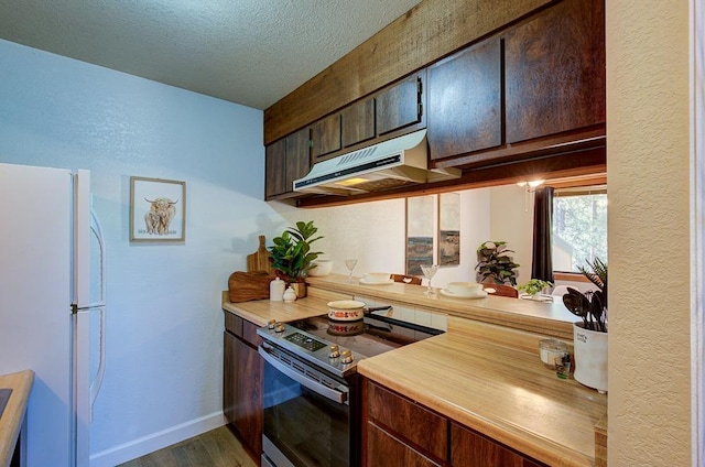 kitchen with freestanding refrigerator, electric range, under cabinet range hood, dark wood finished floors, and baseboards