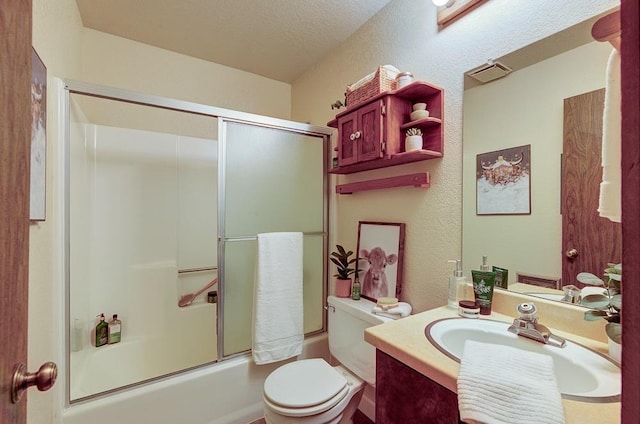 full bath with shower / bath combination with glass door, vanity, and toilet