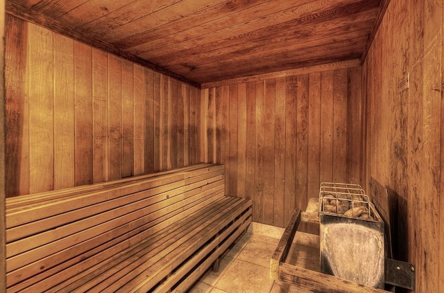 sauna featuring wooden ceiling and wooden walls