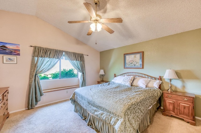 bedroom featuring a textured ceiling, light colored carpet, lofted ceiling, baseboards, and ceiling fan