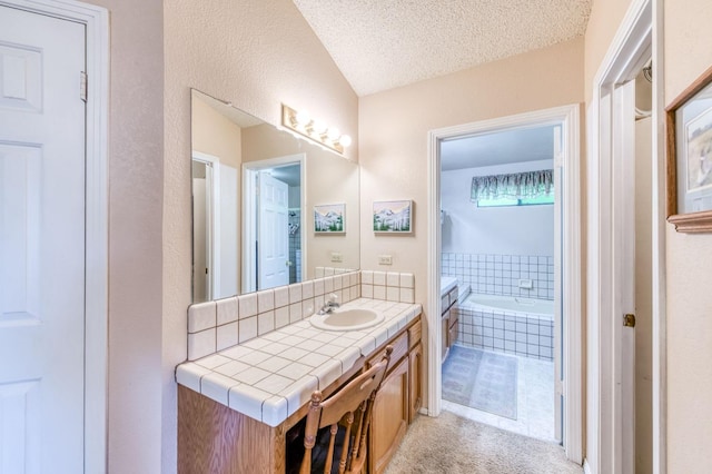 bathroom with vanity, a garden tub, and a textured ceiling
