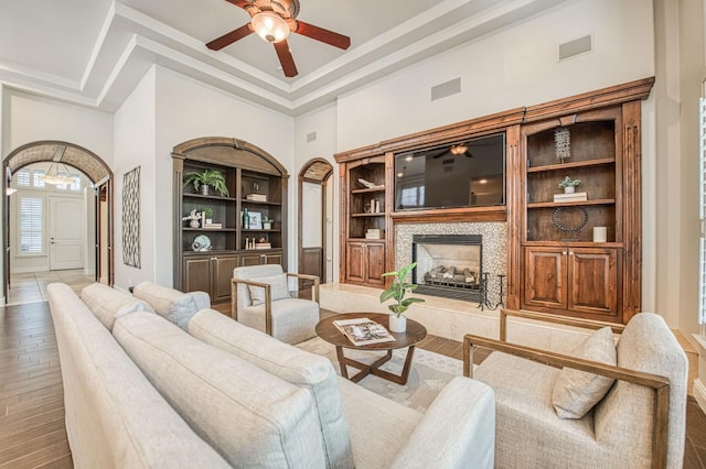 7762 N Hillsdale Dr, Fresno, CA 93720 - living room featuring a high ceiling, wood-type flooring, ceiling fan, a fireplace, and built in features