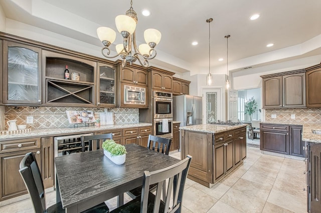 7762 N Hillsdale Dr, Fresno, CA 93720 - kitchen featuring tasteful backsplash, appliances with stainless steel finishes, glass insert cabinets, a chandelier, and recessed lighting