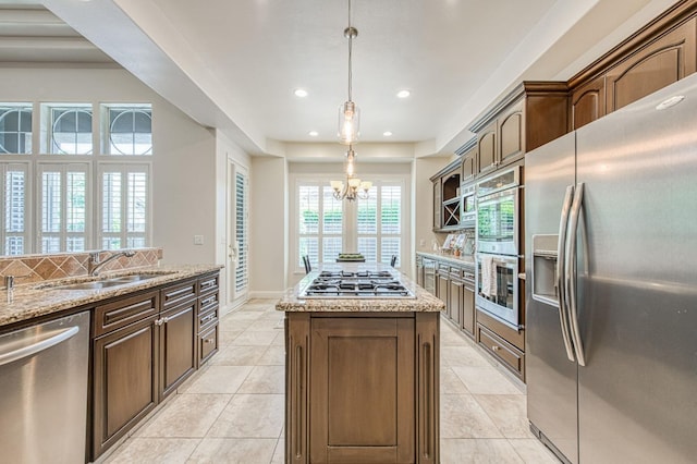 7762 N Hillsdale Dr, Fresno, CA 93720 - kitchen featuring stainless steel appliances, a chandelier, recessed lighting, a center island, and light stone counters