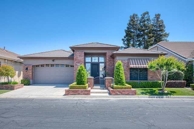 7762 N Hillsdale Dr, Fresno, CA 93720 - view of front facade with a garage, brick siding, concrete driveway, and a tiled roof