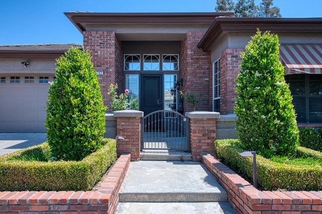 7762 N Hillsdale Dr, Fresno, CA 93720 - entrance to property featuring brick siding, a gate, and an attached garage