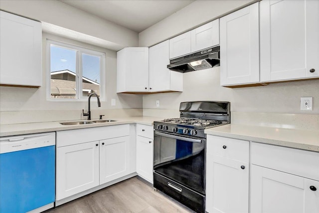 19745 Hemlock Ln, Lemoore, CA 93245 - kitchen featuring dishwashing machine, under cabinet range hood, gas stove, light wood-style flooring, and light countertops