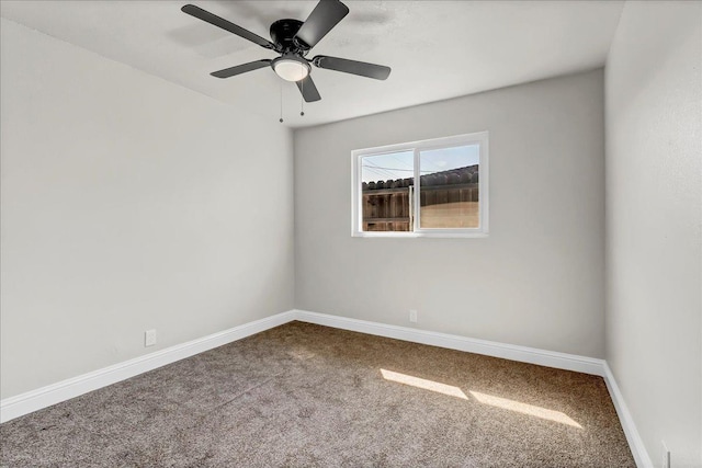 unfurnished room with carpet, baseboards, and a ceiling fan