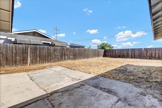 fenced backyard with a patio area