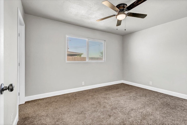 unfurnished room with carpet flooring, ceiling fan, and baseboards