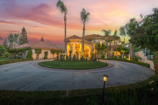 2589 W Lake Van Ness Cir, Fresno, CA 93711 - mediterranean / spanish-style home with curved driveway, a tiled roof, and stucco siding