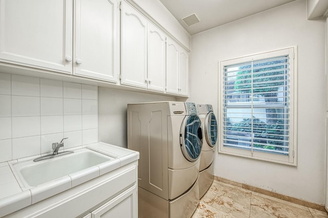 2589 W Lake Van Ness Cir, Fresno, CA 93711 - laundry room featuring washing machine and dryer, cabinet space, and baseboards