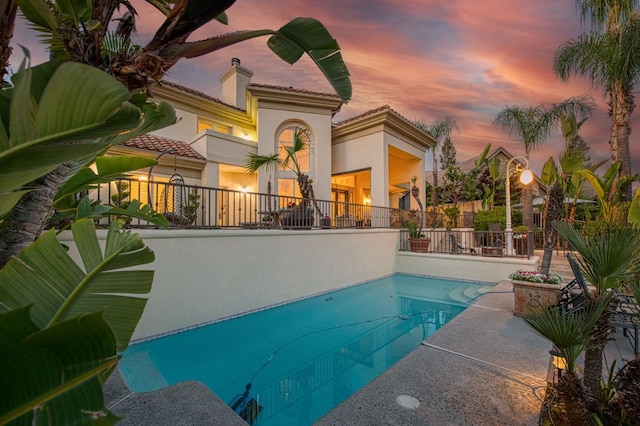 2589 W Lake Van Ness Cir, Fresno, CA 93711 - pool at dusk with fence