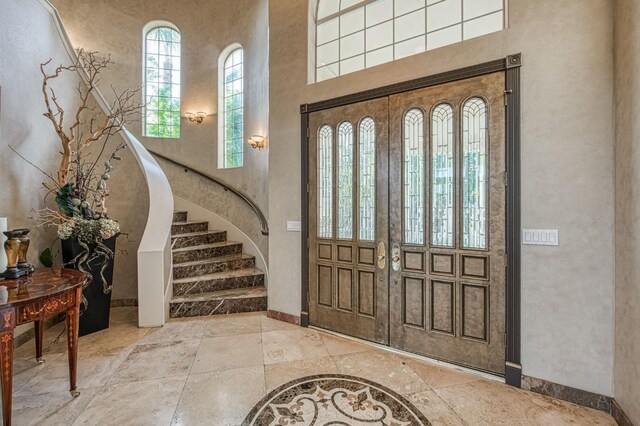 2589 W Lake Van Ness Cir, Fresno, CA 93711 - foyer with a high ceiling, baseboards, stairway, and stone tile floors