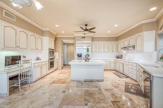 2589 W Lake Van Ness Cir, Fresno, CA 93711 - kitchen featuring appliances with stainless steel finishes, under cabinet range hood, a center island, ornamental molding, and a ceiling fan