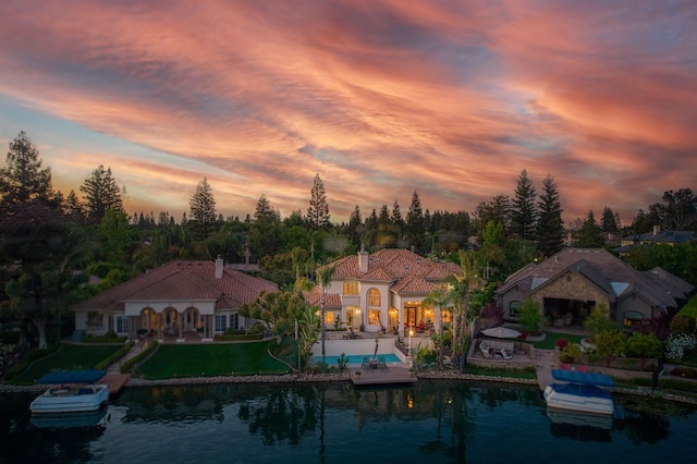 2589 W Lake Van Ness Cir, Fresno, CA 93711 - back of house with a patio, an outdoor pool, a water view, a chimney, and a tile roof