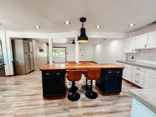 7784 S Del Rey Ave, Del Rey, CA 93616 - kitchen featuring wood counters, a center island, white cabinetry, and recessed lighting