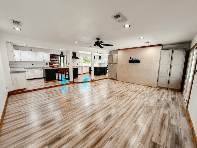 7784 S Del Rey Ave, Del Rey, CA 93616 - unfurnished living room featuring light wood-style flooring, recessed lighting, ceiling fan, and baseboards