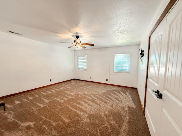 7784 S Del Rey Ave, Del Rey, CA 93616 - empty room featuring ceiling fan, carpet, baseboards, and a textured ceiling