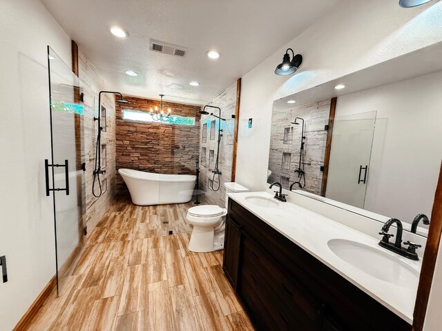 7784 S Del Rey Ave, Del Rey, CA 93616 - bathroom featuring a shower stall, a freestanding tub, double vanity, toilet, and wood finished floors