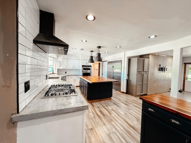 7784 S Del Rey Ave, Del Rey, CA 93616 - kitchen with wood counters, extractor fan, appliances with stainless steel finishes, a sink, and recessed lighting