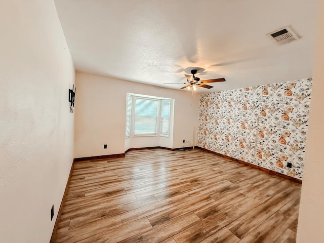 7784 S Del Rey Ave, Del Rey, CA 93616 - spare room with a ceiling fan, baseboards, wallpapered walls, and light wood finished floors
