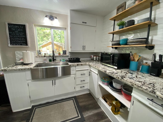 50740 Chu Ranch Rd, Oakhurst, CA 93644 - kitchen featuring a sink, open shelves, white cabinets, light stone counters, and dark wood-style flooring