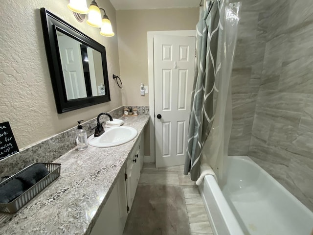 50740 Chu Ranch Rd, Oakhurst, CA 93644 - full bathroom with vanity, a textured wall, and shower / tub combo
