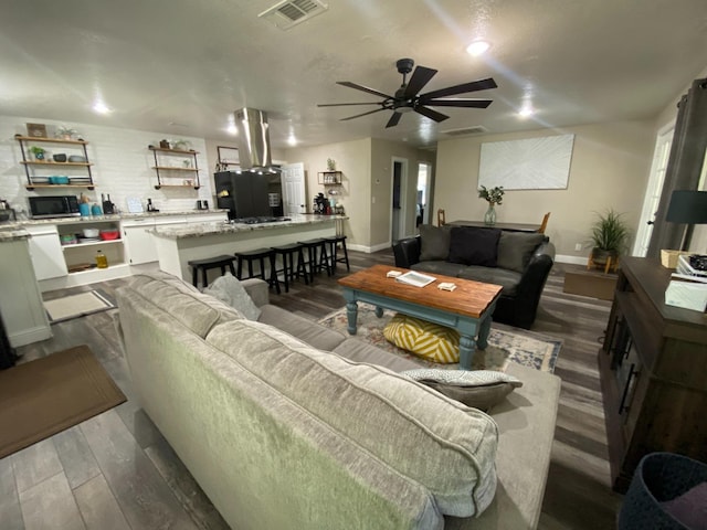 50740 Chu Ranch Rd, Oakhurst, CA 93644 - living area featuring dark wood finished floors, a ceiling fan, and baseboards