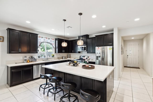 2315 Creekview Dr, Merced, CA 95340 - kitchen with appliances with stainless steel finishes, a sink, light countertops, light tile patterned floors, and recessed lighting
