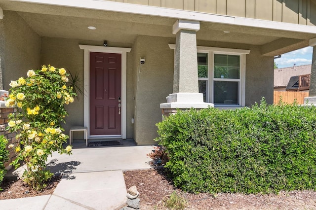 2315 Creekview Dr, Merced, CA 95340 - view of exterior entry with board and batten siding, stucco siding, and a porch