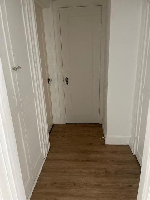 hallway with wood finished floors