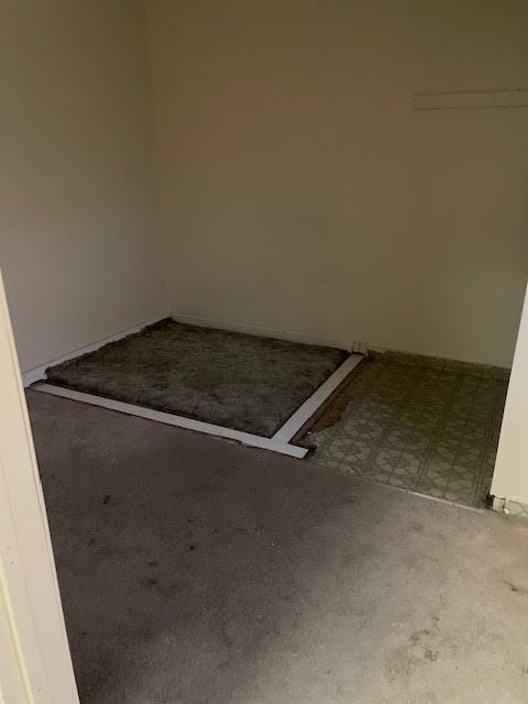 spare room featuring tile patterned floors and carpet flooring