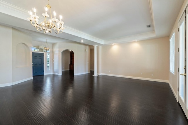 3365 N Emperor Ave, Fresno, CA 93737 - unfurnished living room with a tray ceiling, arched walkways, a chandelier, dark wood finished floors, and baseboards