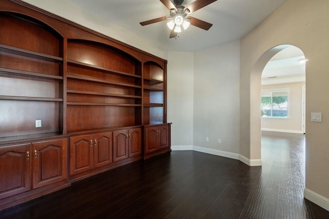 3365 N Emperor Ave, Fresno, CA 93737 - unfurnished room with arched walkways, ceiling fan, baseboards, and dark wood finished floors