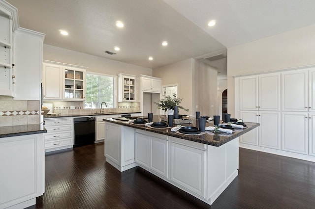 3365 N Emperor Ave, Fresno, CA 93737 - kitchen featuring dishwasher, arched walkways, a sink, white cabinetry, and decorative backsplash