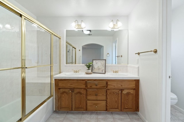 3365 N Emperor Ave, Fresno, CA 93737 - bathroom with toilet, tasteful backsplash, double vanity, and bath / shower combo with glass door