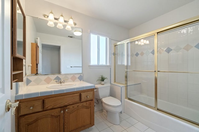 3365 N Emperor Ave, Fresno, CA 93737 - full bathroom featuring tile patterned flooring, toilet, vanity, and enclosed tub / shower combo