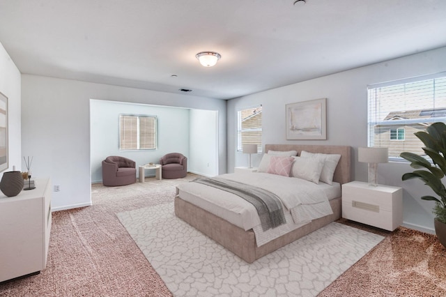 bedroom with carpet, multiple windows, and baseboards