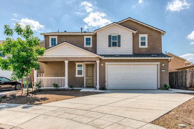 view of front of property with covered porch, concrete driveway, stucco siding, and fence