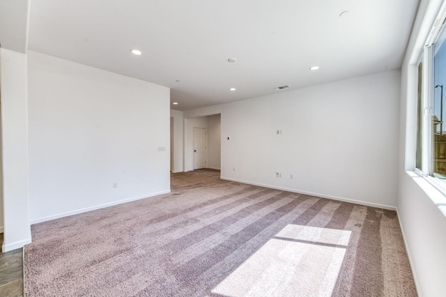 unfurnished room with recessed lighting, carpet floors, and baseboards